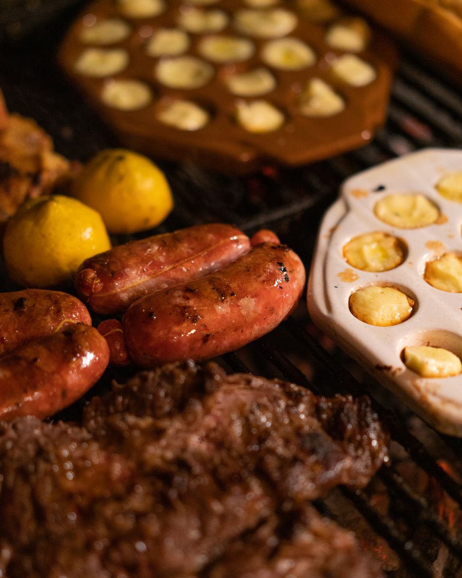 Parrilla con chorizos, carne y provoletas a las brasas
